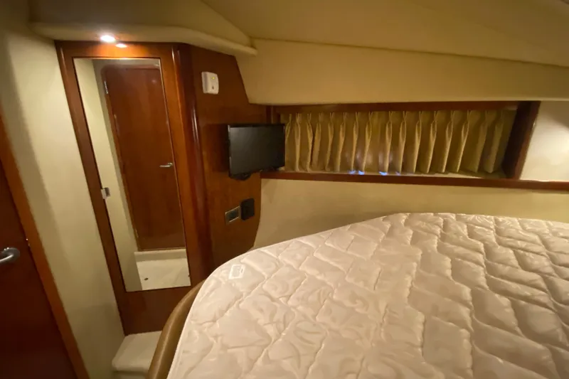 Slide: The Image of Interior cabin of 2006 Sea Ray 38 Sundancer with bed, mirror, and TV. - 31