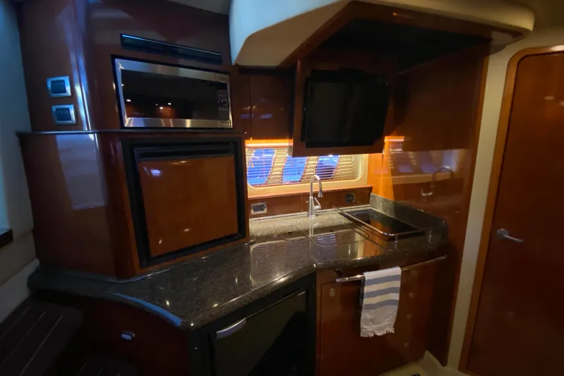Slide: The Image of Luxurious 2006 Sea Ray 38 Sundancer yacht kitchen with modern appliances and sleek design. - 22