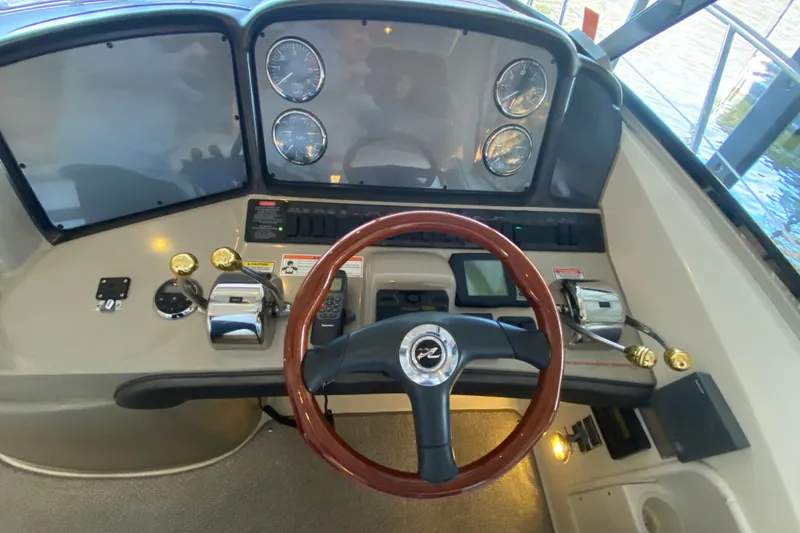 Slide: The Image of Helm of 2006 Sea Ray 38 Sundancer with gauges and wooden steering wheel. - 17
