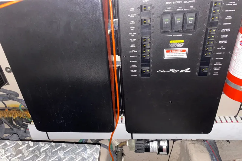 Slide: The Image of Electrical panel of a 2006 Sea Ray 38 Sundancer boat with safety warning. - 42