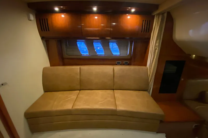Slide: The Image of Interior of 2006 Sea Ray 38 Sundancer with leather seating and wooden cabinetry. - 28
