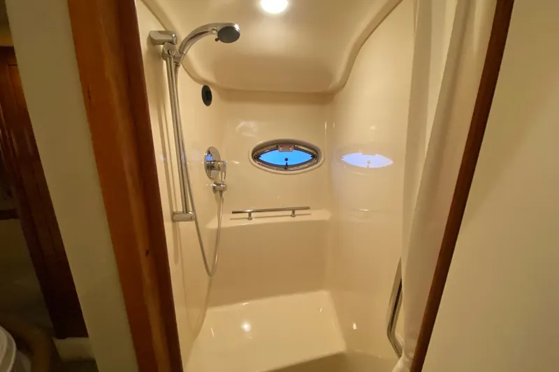 Slide: The Image of Shower area in 2006 Sea Ray 38 Sundancer yacht with porthole window. - 34