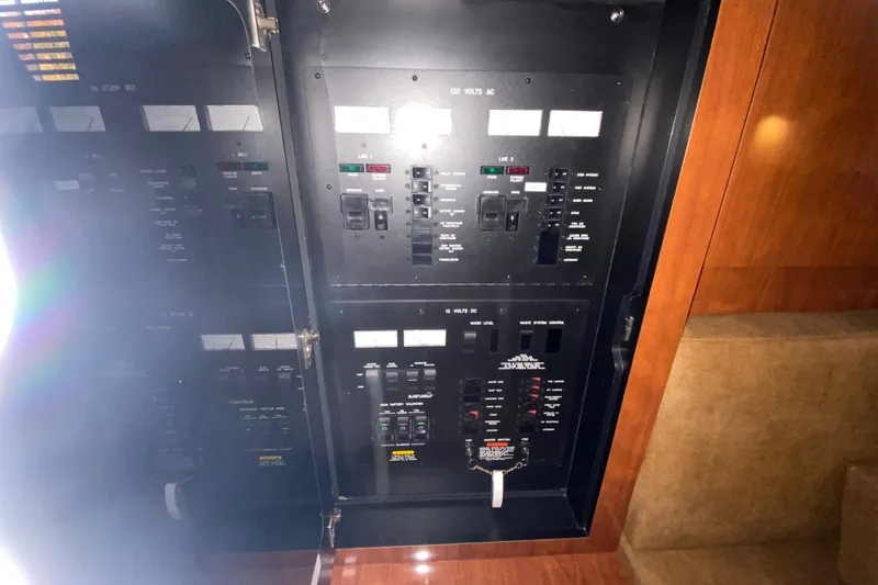 Slide: The Image of Electrical panel inside a 2006 Sea Ray 38 Sundancer yacht, showcasing control switches. - 38