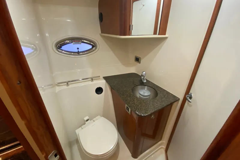 Slide: The Image of Luxurious bathroom in 2006 Sea Ray 38 Sundancer yacht with modern fixtures and porthole window. - 33