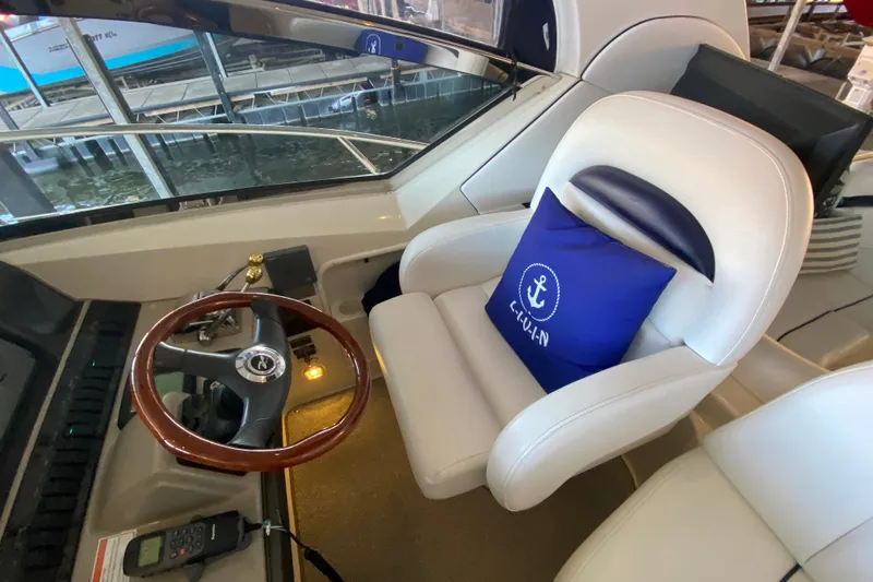 Slide: The Image of Captain's seat and helm of 2006 Sea Ray 38 Sundancer yacht with blue anchor pillow. - 16