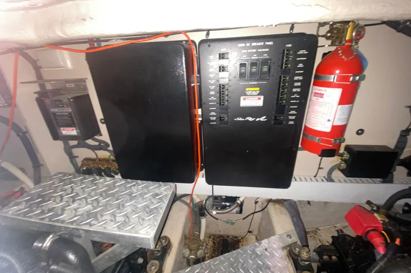 Slide: The Image of Engine room of 2006 Sea Ray 38 Sundancer with electrical panel and fire extinguisher. - 48