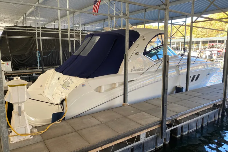 Slide: The Image of 2006 Sea Ray 38 Sundancer yacht docked in a covered marina slip. - 50