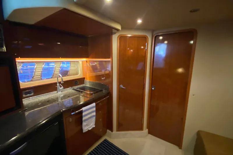 Slide: The Image of Interior of 2006 Sea Ray 38 Sundancer yacht with sleek kitchen and wooden cabinetry. - 35