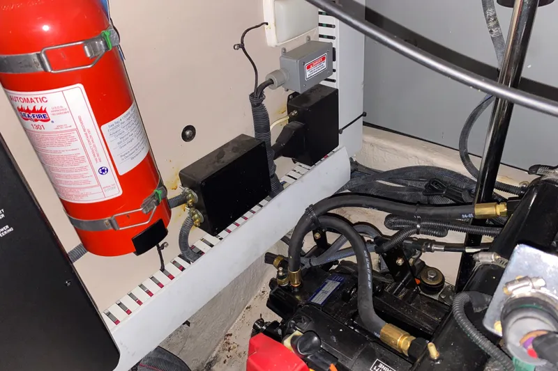 Slide: The Image of Engine room of 2006 Sea Ray 38 Sundancer with fire extinguisher and wiring components. - 44