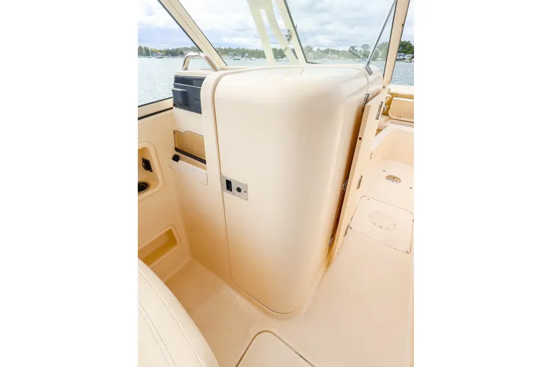 Slide: The Image of Interior view of a 2020 Grady-White Freedom 235 boat, showcasing sleek design and storage. - 15