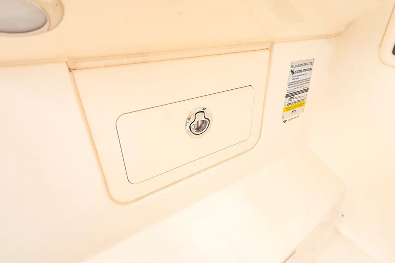 Slide: The Image of 2020 Grady-White Freedom 235 boat storage compartment with capacity label. - 13