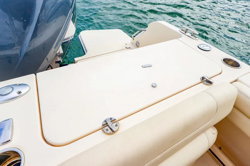 Slide: The Image of 2020 Grady-White Freedom 235 boat deck with seating, near water. - 19