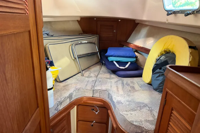Slide: The Image of 1997 Island Packet 37 interior cabin with cushions, life jacket, and storage. - 14