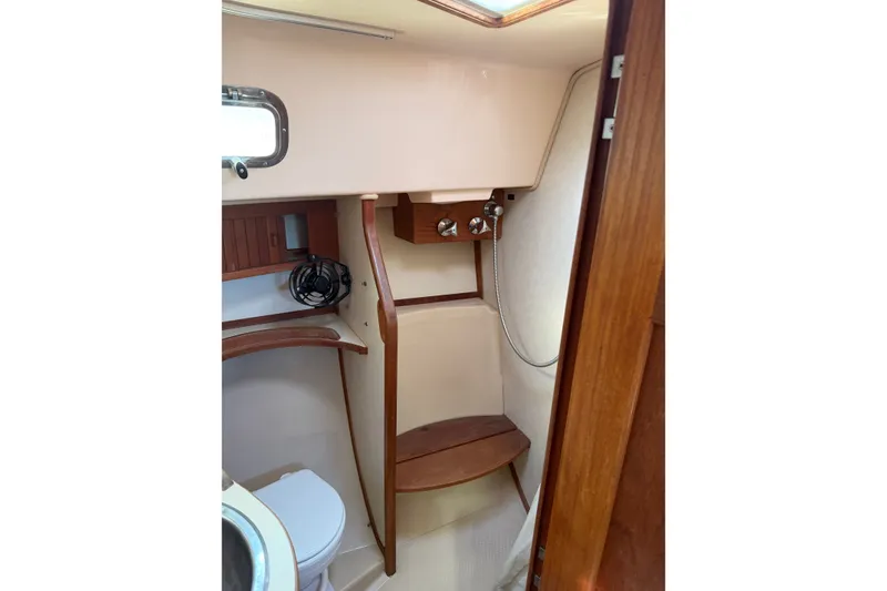 Slide: The Image of 1997 Island Packet 37 yacht bathroom with wooden accents and compact design. - 15
