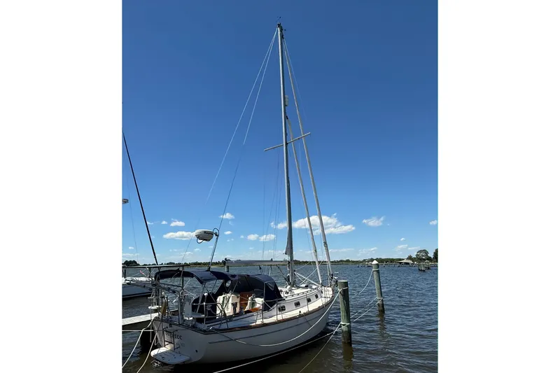 Slide: The Image of 1997 Island Packet 37 sailboat docked on a sunny day with clear blue skies. - 3
