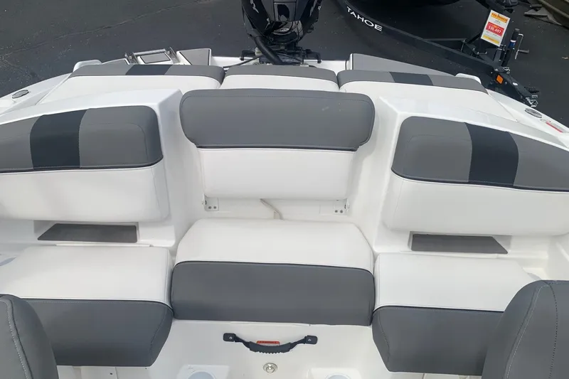 Slide: The Image of 2025 Tahoe T21 boat interior with gray and white cushioned seating. - 7