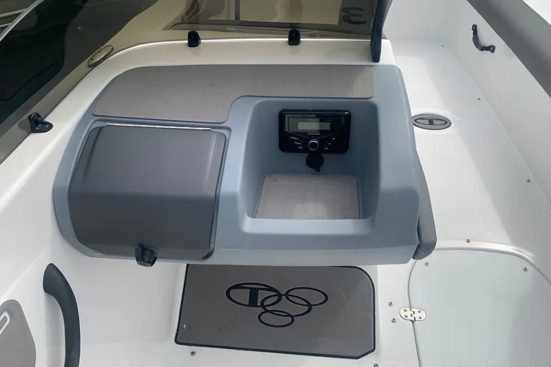 Slide: The Image of 2025 Tahoe T21 boat dashboard with stereo system and storage compartment. - 3