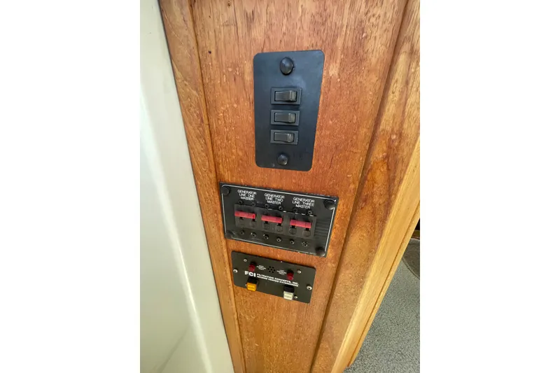 Slide: The Image of Control panel on 1995 Bayliner 4788 Pilot House Motoryacht, featuring switches and circuit breakers. - 19