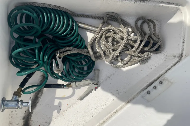 Slide: The Image of Coiled green hose and rope on 1995 Bayliner 4788 Pilot House Motoryacht deck. - 43