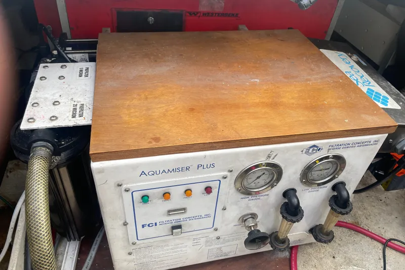 Slide: The Image of Aquamiser Plus watermaker on 1995 Bayliner 4788 Pilot House Motoryacht, featuring pressure gauges and controls. - 46