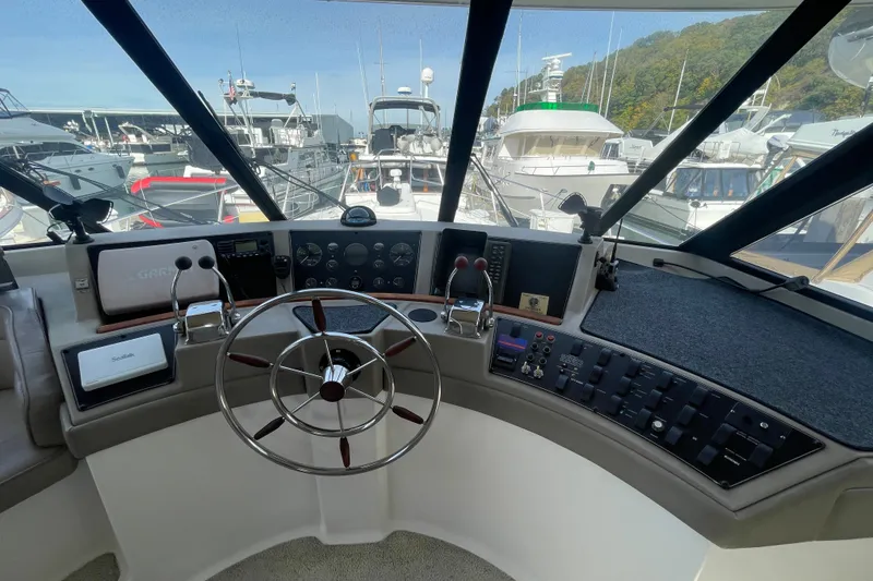 Slide: The Image of 1995 Bayliner 4788 Pilot House Motoryacht helm with steering wheel and control panel. - 20