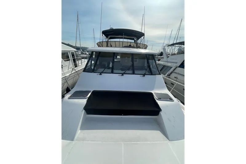 Slide: The Image of 1995 Bayliner 4788 Pilot House Motoryacht docked at marina, showcasing sleek design. - 38