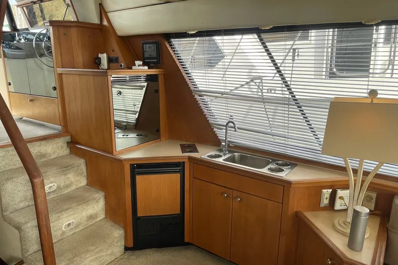Slide: The Image of Interior of 1995 Bayliner 4788 Pilot House Motoryacht with kitchenette and stairs. - 15