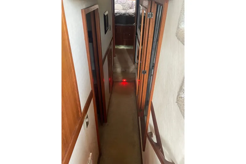 Slide: The Image of Interior hallway of 1995 Bayliner 4788 Pilot House Motoryacht with wooden accents. - 24