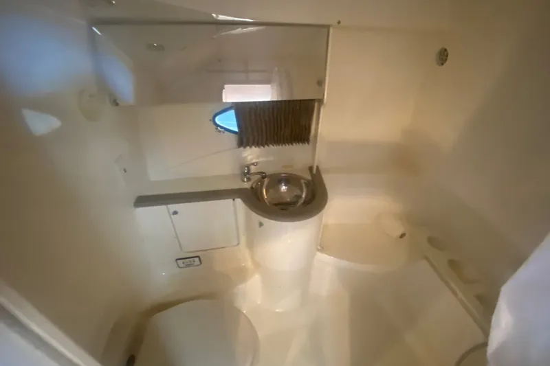 Slide: The Image of Interior of 2001 Formula 370 Super Sport boat bathroom with sink and porthole. - 34