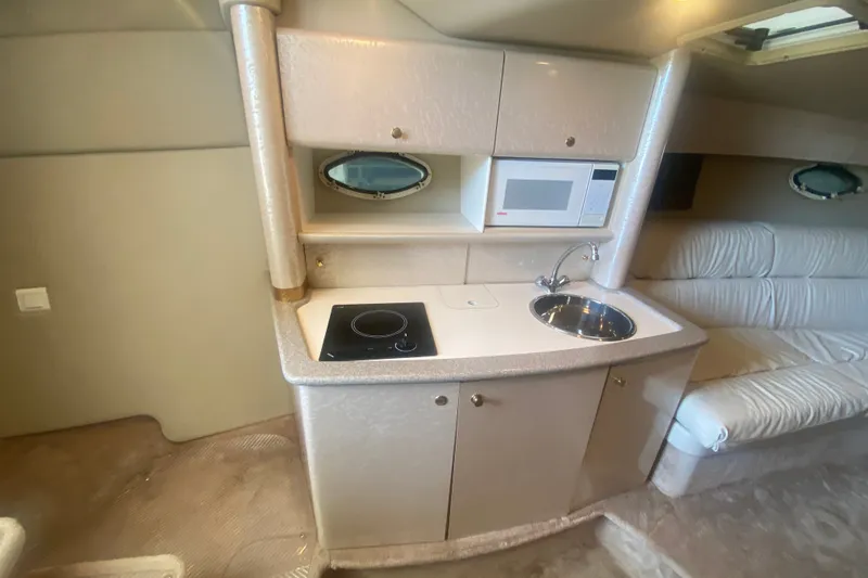 Slide: The Image of Interior of a 2001 Formula 370 Super Sport boat with kitchenette and seating area. - 27