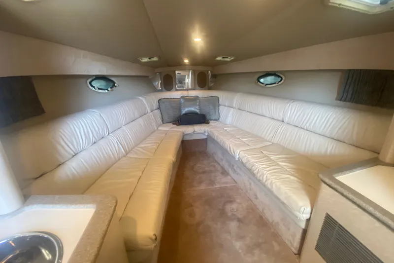 Slide: The Image of Interior of 2001 Formula 370 Super Sport boat with white leather seating and porthole windows. - 28