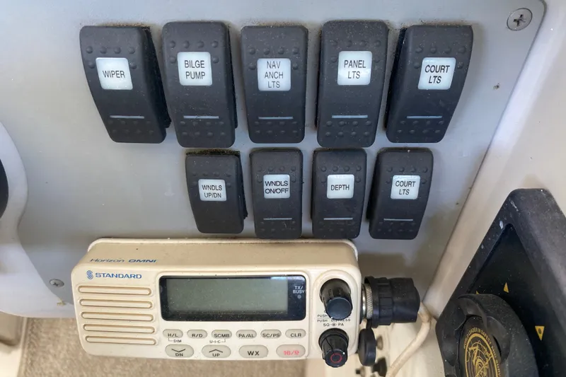 Slide: The Image of Control panel of a 2001 Formula 370 Super Sport boat with switches and radio. - 24