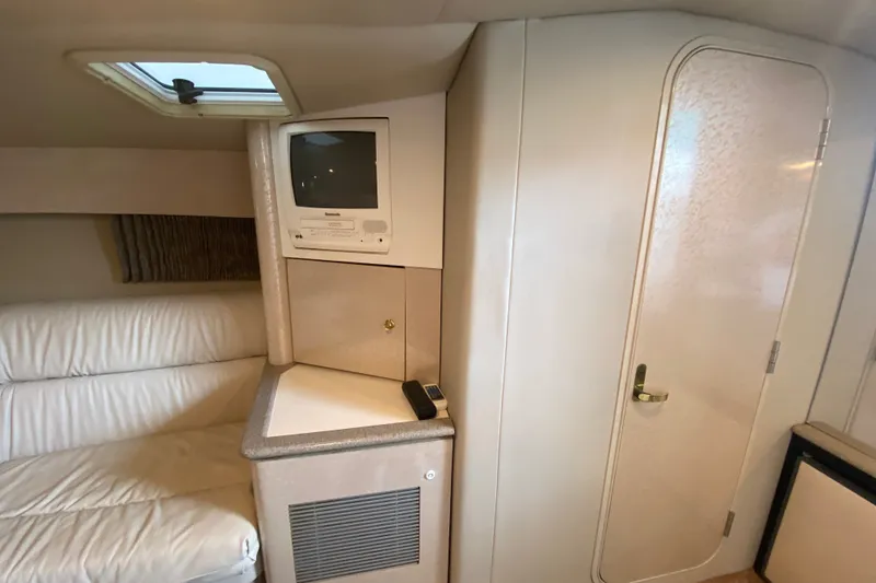 Slide: The Image of Interior of 2001 Formula 370 Super Sport with TV, white seating, and cabin door. - 29