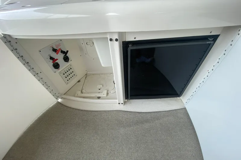 Slide: The Image of Interior view of a 2001 Formula 370 Super Sport boat, featuring control panel and storage. - 14