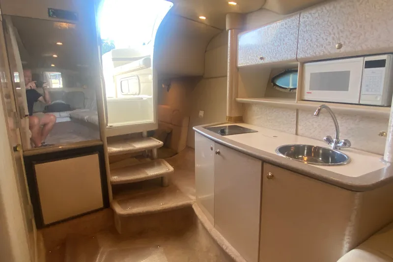 Slide: The Image of Interior of a 2001 Formula 370 Super Sport yacht with kitchenette and seating area. - 33