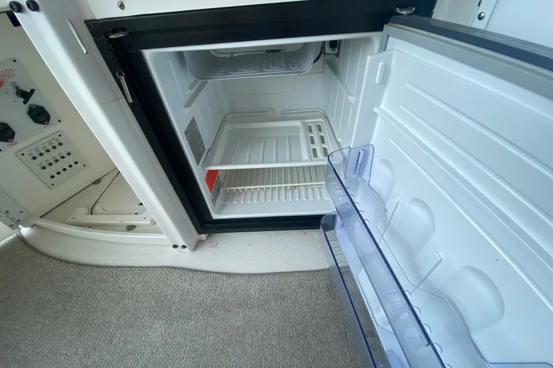 Slide: The Image of Open refrigerator inside a 2001 Formula 370 Super Sport boat, showing empty shelves. - 15