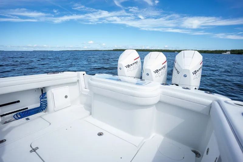 Slide: The Image of 2021 Yellowfin 36 Offshore boat with triple outboard engines on open water. - 17