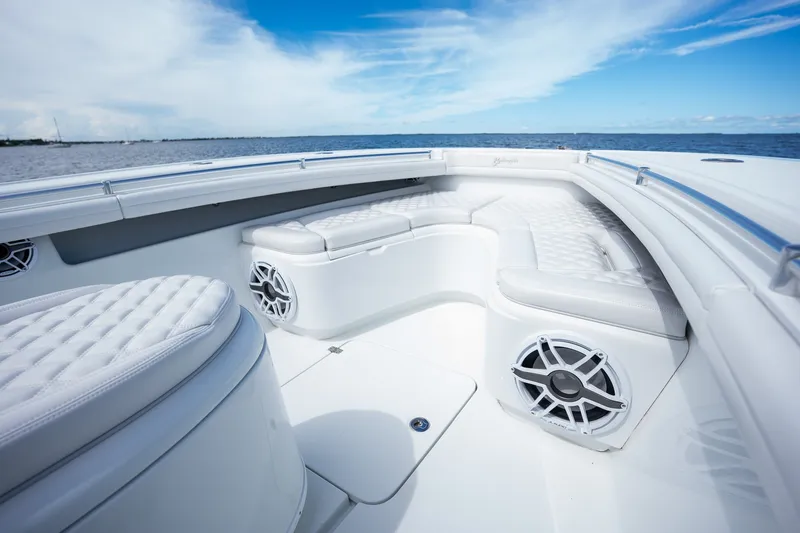 Slide: The Image of 2021 Yellowfin 36 Offshore boat interior with white seating and ocean view. - 16