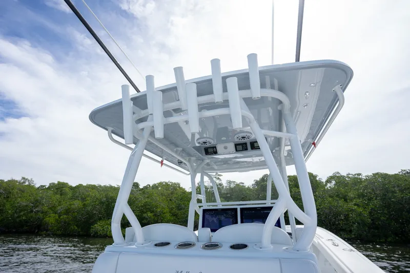 Slide: The Image of 2021 Yellowfin 36 Offshore boat with T-top and rod holders, set against a scenic backdrop. - 39