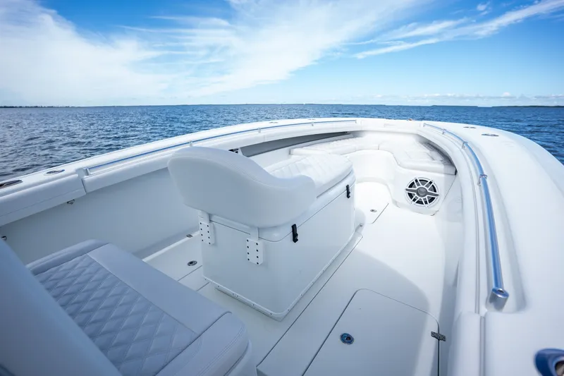 Slide: The Image of 2021 Yellowfin 36 Offshore boat interior with white seating, ocean view, and blue sky. - 15