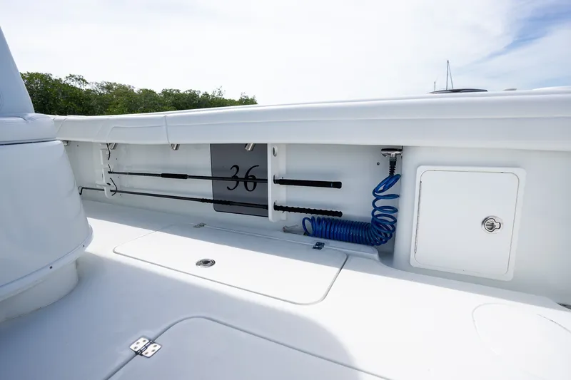 Slide: The Image of 2021 Yellowfin 36 Offshore boat deck with storage compartment and coiled hose. - 40