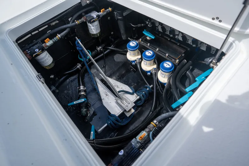 Slide: The Image of Engine compartment of a 2021 Yellowfin 36 Offshore boat, showcasing fuel filters and hoses. - 34