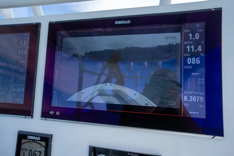 Slide: The Image of Simrad display on 2021 Yellowfin 36 Offshore boat showing navigation and depth data. - 23