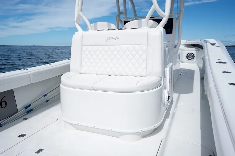 Slide: The Image of 2021 Yellowfin 36 Offshore boat with white seating, on open water under blue sky. - 31