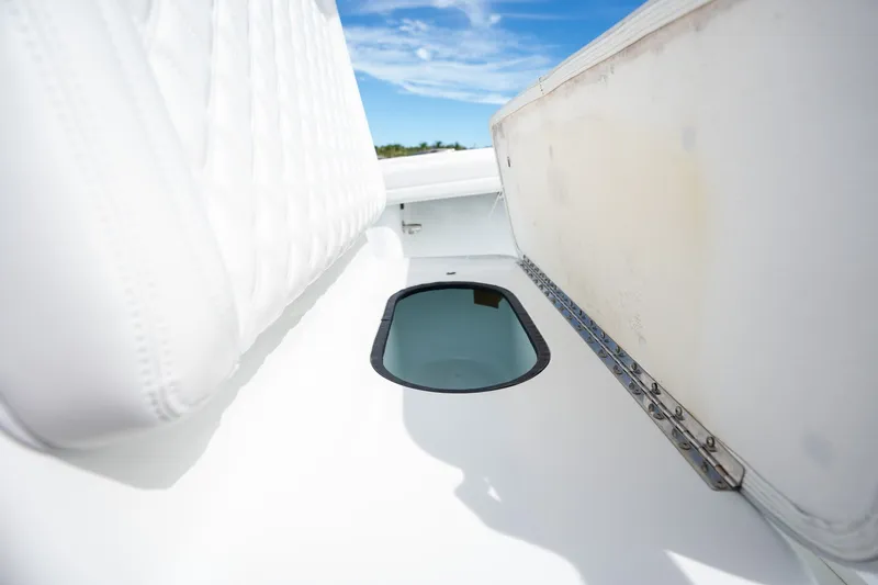 Slide: The Image of 2021 Yellowfin 36 Offshore boat interior with open hatch under clear blue sky. - 28