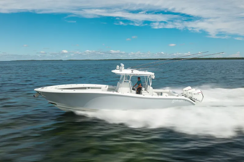 Slide: The Image of 2021 Yellowfin 36 Offshore boat cruising on open water under a clear blue sky. - 13