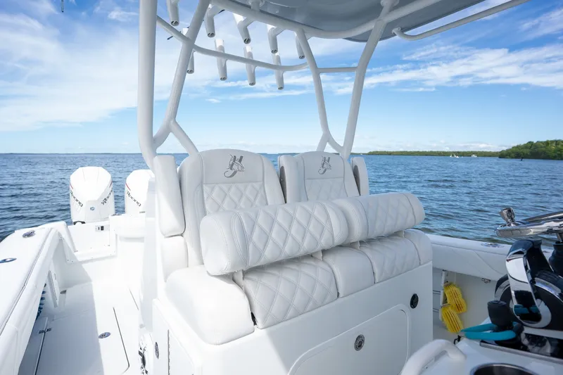 Slide: The Image of 2021 Yellowfin 36 Offshore boat interior with white seating, ocean view, and clear sky. - 29