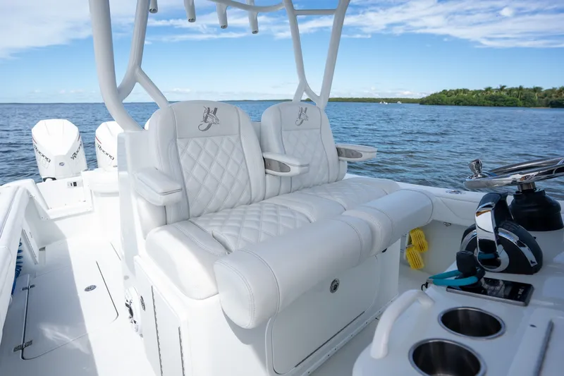 Slide: The Image of 2021 Yellowfin 36 Offshore boat with luxurious white seating and ocean backdrop. - 30
