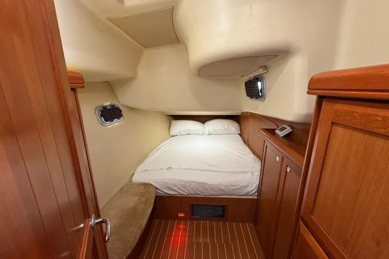 Slide: The Image of Cozy cabin interior of 2009 Hunter 49 yacht with wooden furnishings and comfortable bedding. - 19