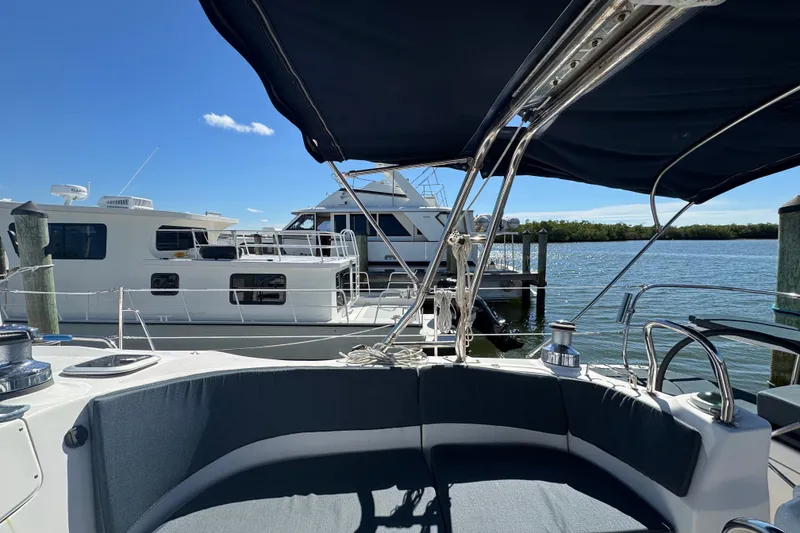 Slide: The Image of Cockpit view of a 2009 Hunter 49 sailboat docked at a marina. - 78
